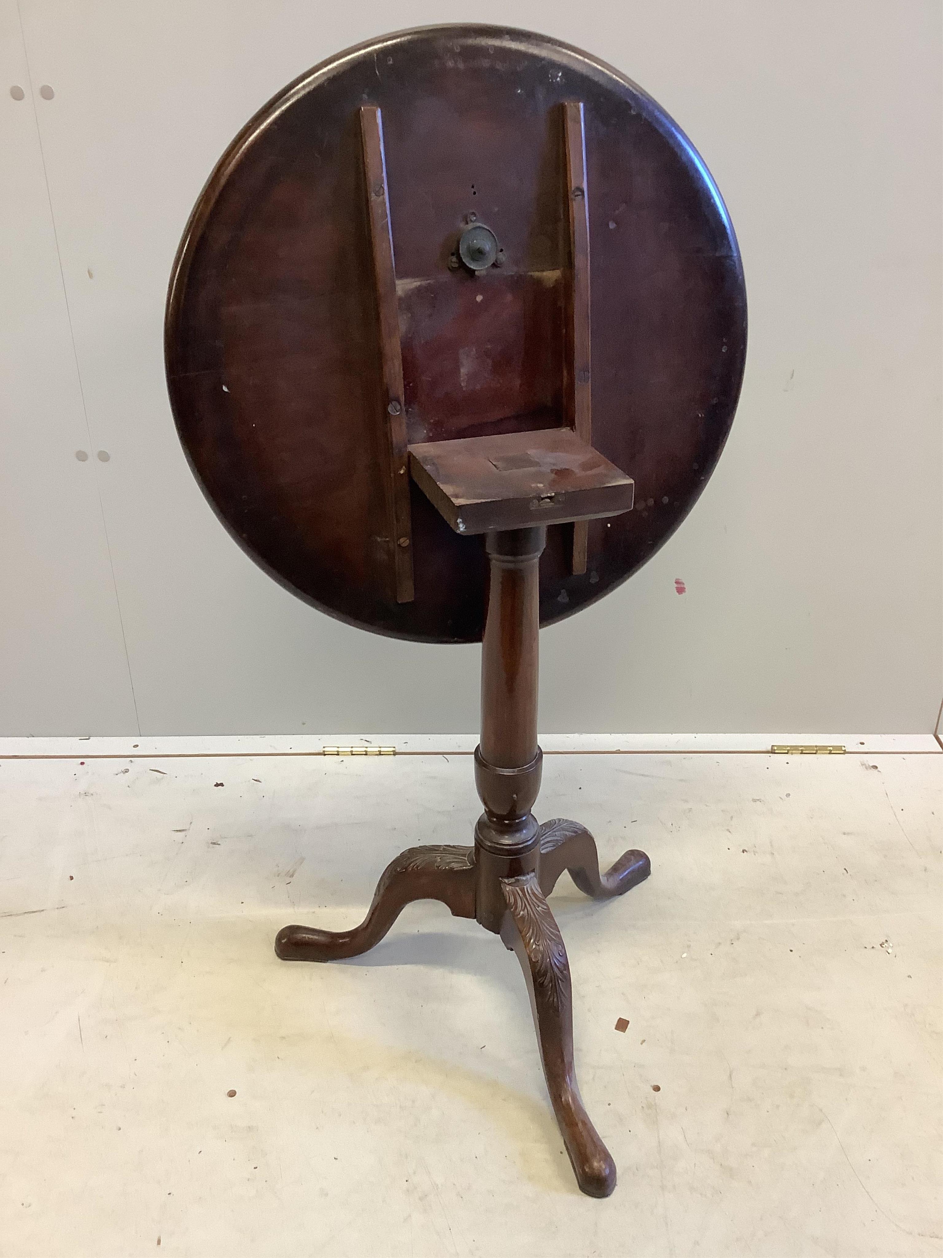 An Edwardian George III style circular mahogany tilt top wine table, on carved cabriole legs, diameter 56cm, height 65cm. Condition - fair